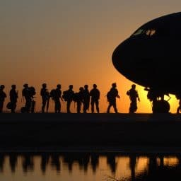 US soldiers boarding an airplane.